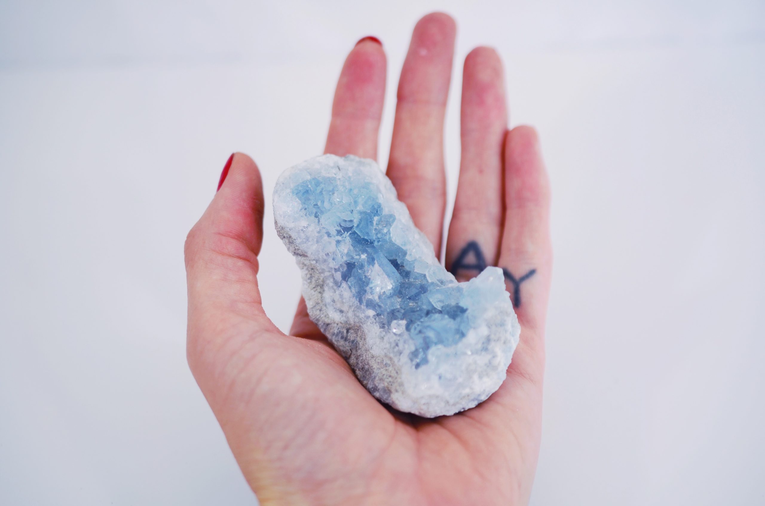 Hand holding blue geode crystal
